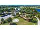 An aerial view shows the playground area surrounded by palm trees and lush landscaping at 6611 Current Dr, Apollo Beach, FL 33572