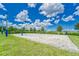 Community sand volleyball court with well-maintained lawn and landscaping at 6611 Current Dr, Apollo Beach, FL 33572