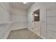 Large walk-in closet with carpet and wire shelving, leading to a bright bathroom with a glass shower at 6611 Current Dr, Apollo Beach, FL 33572