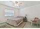 Bright bedroom with a large window, neutral walls and floors, and comfortable furnishings at 711 6Th Ne St, Largo, FL 33770