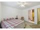 Bedroom featuring neutral walls and floors, a comfortable bed, and an attached bathroom at 711 6Th Ne St, Largo, FL 33770
