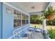 Cozy front porch featuring comfortable seating and a view of the landscaped yard at 711 6Th Ne St, Largo, FL 33770
