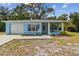 Charming, light-blue single story home with attached garage and a cozy, welcoming front yard at 711 6Th Ne St, Largo, FL 33770