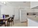 Bright and airy kitchen featuring white appliances, laminate countertops, and a dining area at 711 6Th Ne St, Largo, FL 33770