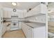 Functional kitchen with clean white cabinetry, essential appliances, and ample counter space at 711 6Th Ne St, Largo, FL 33770