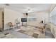 Cozy living room features neutral walls, tile flooring, ceiling fan, and bright natural light from the window at 711 6Th Ne St, Largo, FL 33770