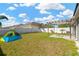 Lush backyard featuring a pergola and ample space to play plus a tent for fun! at 7705 Dragon Fly Loop, Gibsonton, FL 33534
