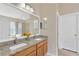 Bright bathroom featuring double sinks, granite countertops, and a large mirror at 7705 Dragon Fly Loop, Gibsonton, FL 33534