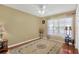 Charming bedroom features hardwood floors, a ceiling fan, and natural light from the window at 7705 Dragon Fly Loop, Gibsonton, FL 33534