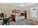 Functional bedroom with bunk beds, a desk, hardwood floors, and a ceiling fan at 7705 Dragon Fly Loop, Gibsonton, FL 33534