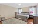 Comfortable bedroom with a gray bed, wood floors, area rug, and coordinating furniture at 7705 Dragon Fly Loop, Gibsonton, FL 33534