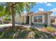 Beautiful house showcasing the garage, white-framed windows, and rock landscaping at 7705 Dragon Fly Loop, Gibsonton, FL 33534