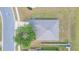 Aerial view of a single Gathering home featuring a mature shade tree and a well-maintained lawn at 7939 Merchantville Cir, Zephyrhills, FL 33540