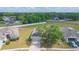 Aerial shot of a well-maintained home with mature landscaping and a driveway at 7939 Merchantville Cir, Zephyrhills, FL 33540
