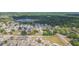 Aerial view of a residential area featuring homes with fenced yards and beautiful landscaping at 7939 Merchantville Cir, Zephyrhills, FL 33540