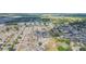 Aerial view of a residential area featuring homes with well-manicured lawns and tree-lined streets at 7939 Merchantville Cir, Zephyrhills, FL 33540