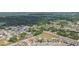 Neighborhood aerial view showing cozy homes surrounded by lush trees and green spaces at 7939 Merchantville Cir, Zephyrhills, FL 33540