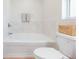 Clean bathroom with white tiled walls and a soaking tub for relaxation at 7939 Merchantville Cir, Zephyrhills, FL 33540