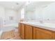 Bright bathroom featuring a double sink vanity, tub, and decorative rug at 7939 Merchantville Cir, Zephyrhills, FL 33540
