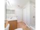 Well-lit bathroom with double sinks, tile shower, and ample storage space at 7939 Merchantville Cir, Zephyrhills, FL 33540