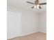 A bright bedroom with a ceiling fan and a large closet provides comfort and ample storage space at 7939 Merchantville Cir, Zephyrhills, FL 33540