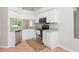 Bright kitchen with white cabinets, granite countertops, and stainless appliances at 7939 Merchantville Cir, Zephyrhills, FL 33540