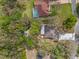 Aerial view of the home's landscaped backyard, pond feature, and proximity to other properties at 9395 Belvedere St, Spring Hill, FL 34608