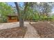 Secluded backyard featuring a brick patio, wooden gazebo, and tranquil landscaping at 9395 Belvedere St, Spring Hill, FL 34608
