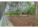 A sprawling backyard with tiled patio and lush landscaping at 9395 Belvedere St, Spring Hill, FL 34608