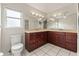 Bathroom with double vanity, dark wood cabinets, and granite countertops at 9395 Belvedere St, Spring Hill, FL 34608