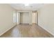 Bedroom features wood-look flooring, closet, and ample natural light from a large window at 9395 Belvedere St, Spring Hill, FL 34608