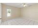 Bedroom featuring tiled floor, ceiling fan, and a window offering natural light at 9395 Belvedere St, Spring Hill, FL 34608