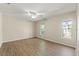 Bedroom with wood-look flooring, a ceiling fan, and natural light from two windows at 9395 Belvedere St, Spring Hill, FL 34608