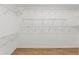 Walk-in closet with ample shelving and laminate floors at 9395 Belvedere St, Spring Hill, FL 34608