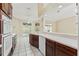 Modern kitchen featuring stainless steel appliances, dark cabinets, and easy access to the outdoor living space at 9395 Belvedere St, Spring Hill, FL 34608