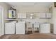 Functional laundry room with washer, dryer, utility sink, and storage cabinets at 9395 Belvedere St, Spring Hill, FL 34608