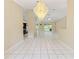 Open living room features tile floors and a decorative chandelier providing an inviting atmosphere at 9395 Belvedere St, Spring Hill, FL 34608