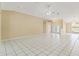 Spacious living room with bright lighting, tile flooring, and convenient access to the front foyer at 9395 Belvedere St, Spring Hill, FL 34608