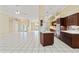 Open-concept living room features tile flooring, modern ceiling fans, and access to the kitchen at 9395 Belvedere St, Spring Hill, FL 34608