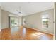 Bright living room featuring hardwood floors and sliding doors providing seamless access to the pool area at 9395 Belvedere St, Spring Hill, FL 34608