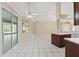 Bright living room boasting tile flooring, ceiling fan, and sliding glass doors to the outdoors at 9395 Belvedere St, Spring Hill, FL 34608