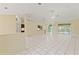 An open-concept living room boasts bright tile flooring, neutral walls, and abundant natural light at 9395 Belvedere St, Spring Hill, FL 34608