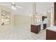 Bright and open living space with tile flooring and views into the kitchen and foyer at 9395 Belvedere St, Spring Hill, FL 34608