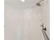 Modern white tiled shower with showerhead and safety bar at 9395 Belvedere St, Spring Hill, FL 34608