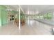 Spacious sunroom featuring tile flooring, a wooden table, dining chairs, and access to the outdoors at 9395 Belvedere St, Spring Hill, FL 34608