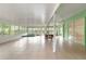 Large sunroom with tile flooring, dining table and chairs, hot tub, ceiling fans, and bright, natural light at 9395 Belvedere St, Spring Hill, FL 34608