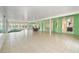 Bright sunroom with tile flooring, ceiling fans, large windows, seating area, dining table and hot tub at 9395 Belvedere St, Spring Hill, FL 34608