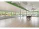 Expansive sunroom with ceiling fans, tile floors, dining set, hot tub, and abundant natural light at 9395 Belvedere St, Spring Hill, FL 34608