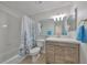 Clean bathroom featuring a tub/shower combination and a modern vanity with storage at 10100 Sailwinds N Blvd # 203, Largo, FL 33773