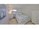 This cozy bedroom features nautical bedding, side table, and a three-tier lamp at 10100 Sailwinds N Blvd # 203, Largo, FL 33773